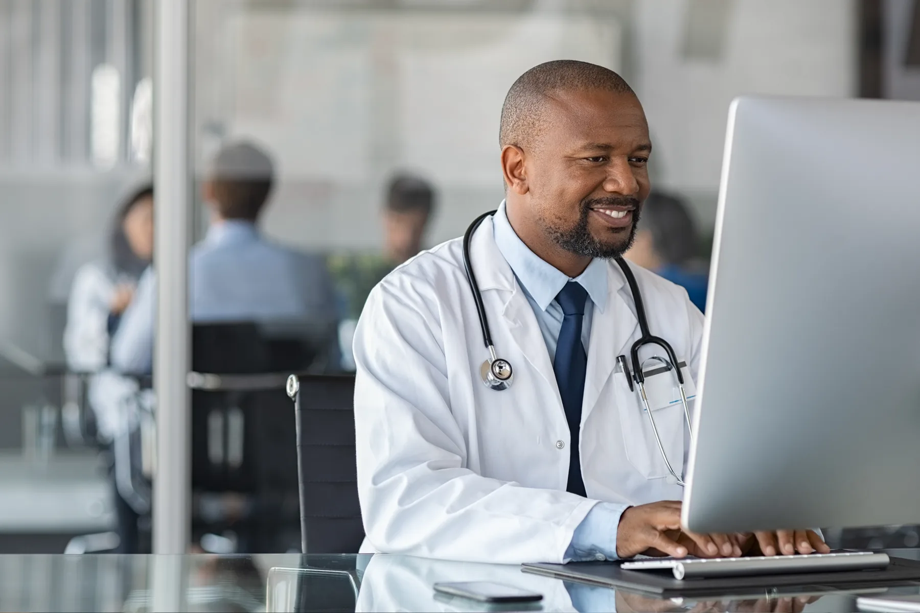 Doctor working at a computer in a clinic