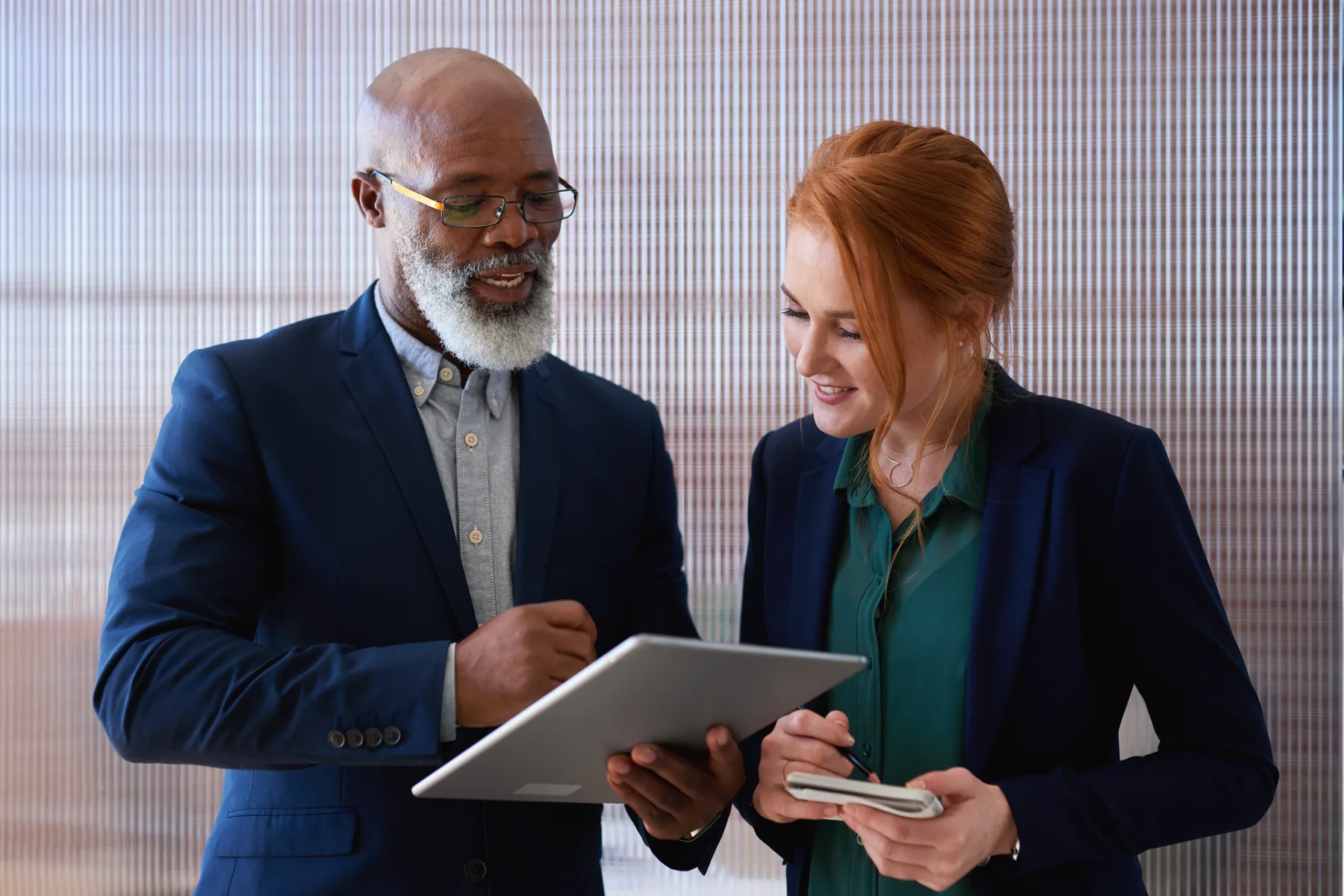 Professional consultants reviewing work on a tablet