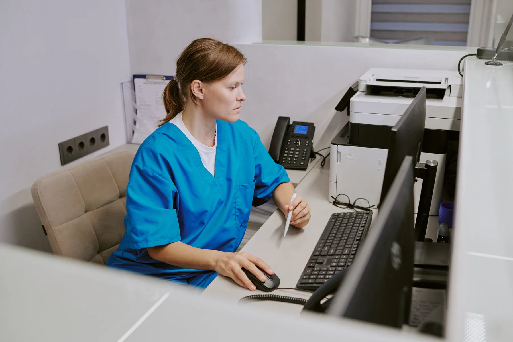 Healthcare clinic staff at a computer workstation